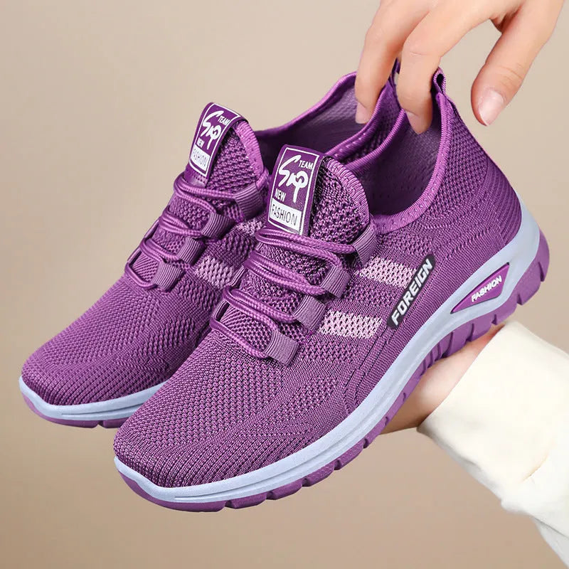 Low-top casual shoes with breathable mesh upper and flat PVC sole in black, grey, purple, or red.