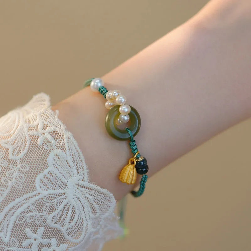 Hand-woven flexible wire watch bracelet with a pearl peace buckle in retro style for women.