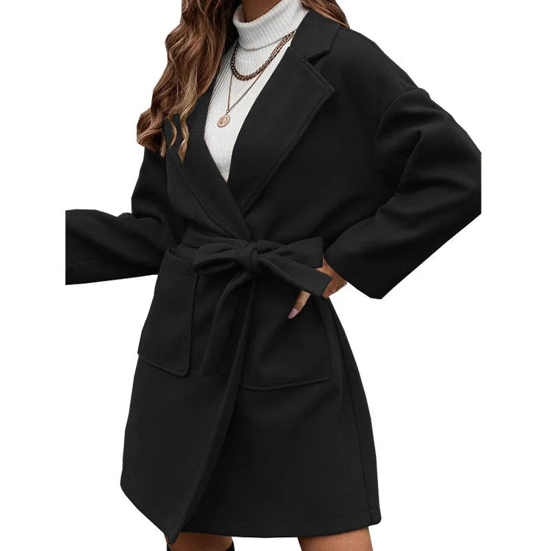 Minimalist long sleeve lapel button coat with a split belt in a loose fit, shown in a choice of colours.