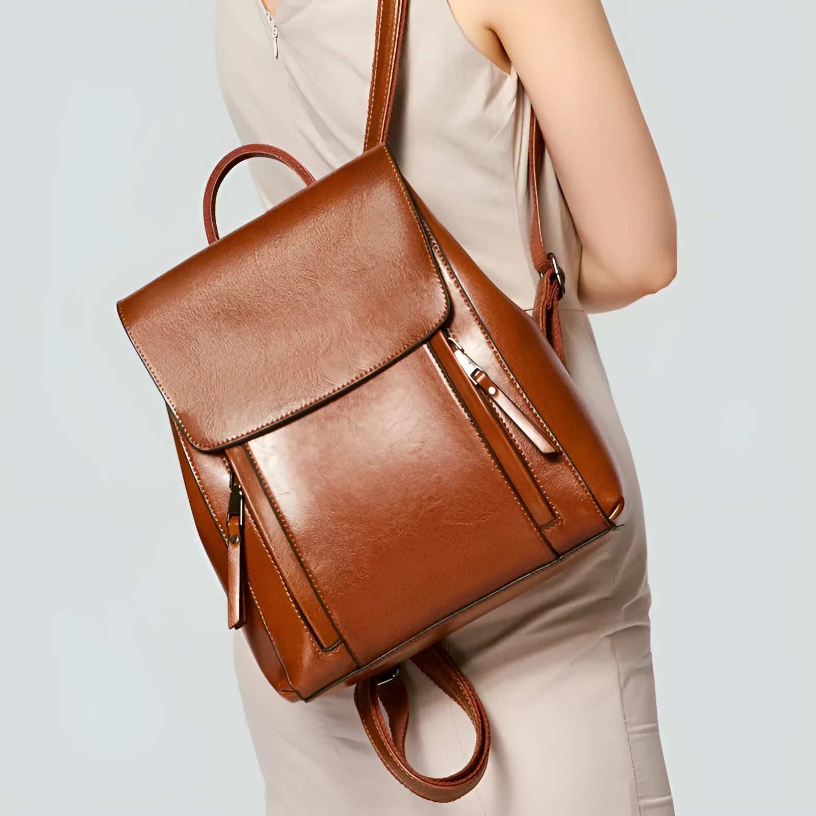 Large black genuine leather women's backpack with soft handle, double straps, and visible stitching.