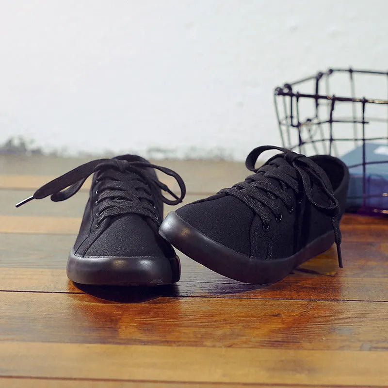 All black Korean-style women's canvas flat shoes with lace-up front and rubber sole