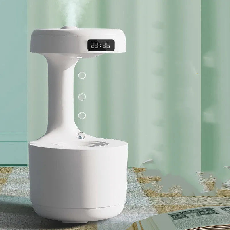 White columnar anti-gravity humidifier with LED clock display and mist output on a wooden desk.