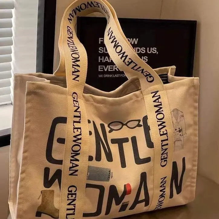 Canvas women's travel tote bag with printed design options including black letters, coloured letters, and pattern styles