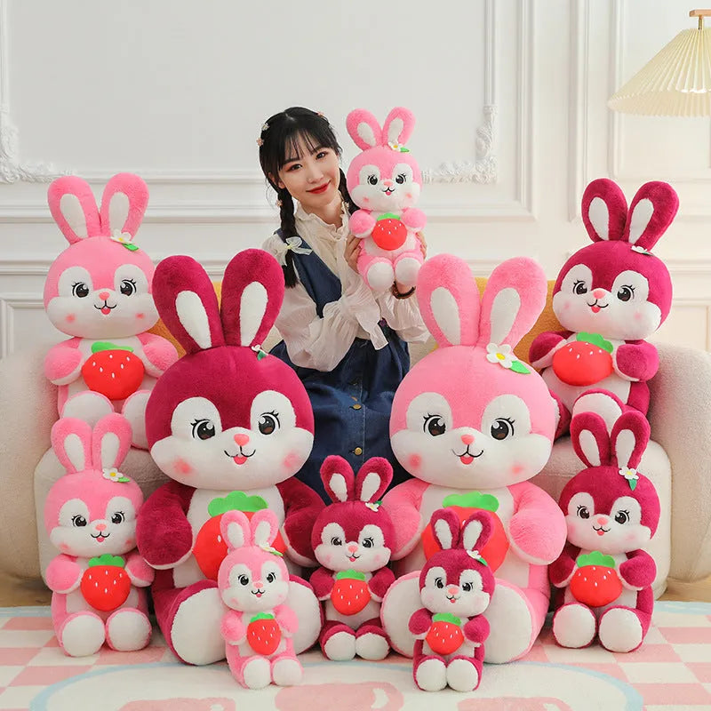 Cartoon strawberry rabbit plush toy doll pillow in pink sitting on a surface