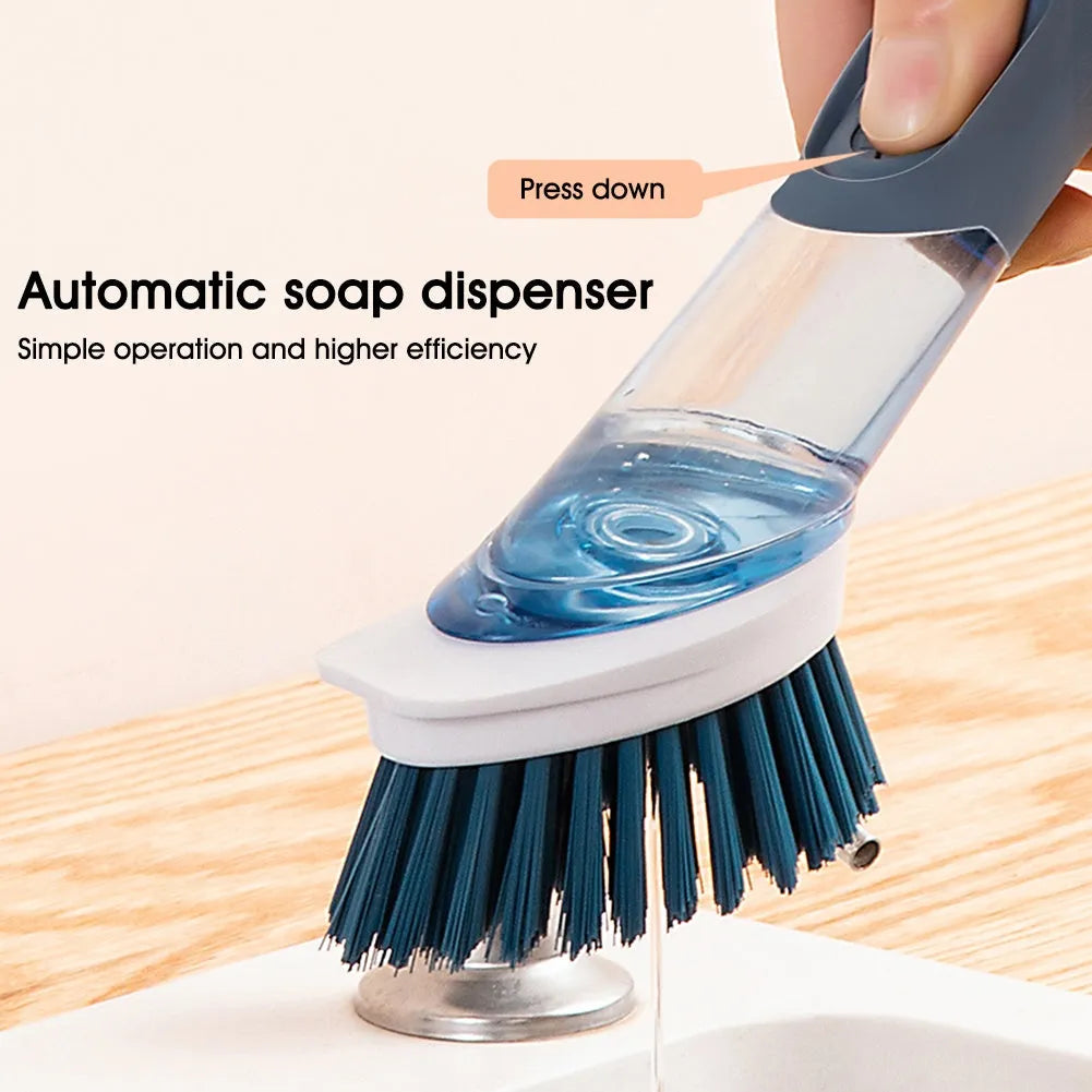 Blue long-handled kitchen dish brush with built-in soap dispenser button, sponge, and scouring block.