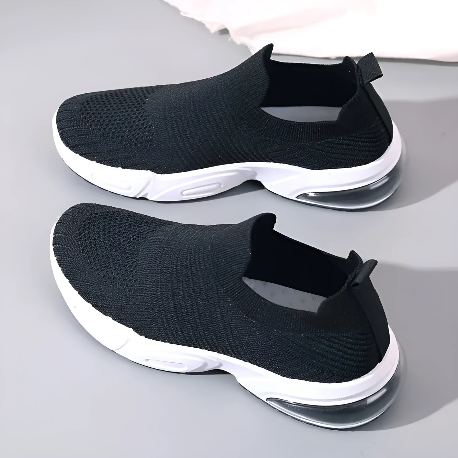 Breathable mesh slip-on lazy sock shoes in black, pink, khaki, and white colours on a PVC sole.