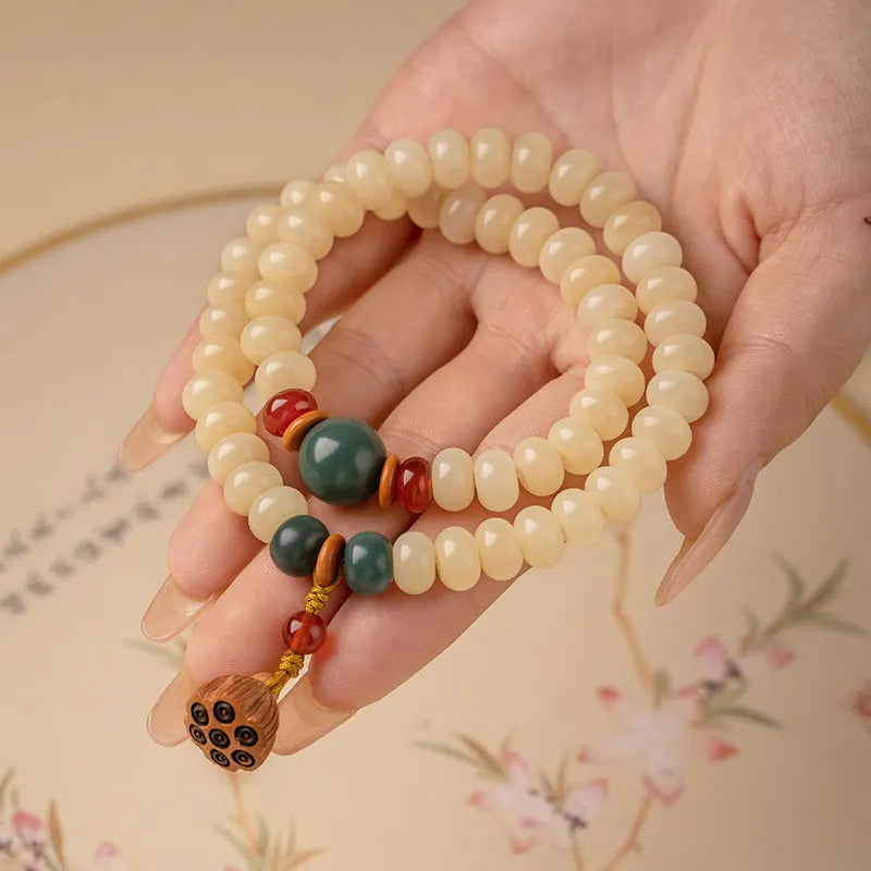 Cream topaz bodhi root wooden bracelet with flat round beads on wrist