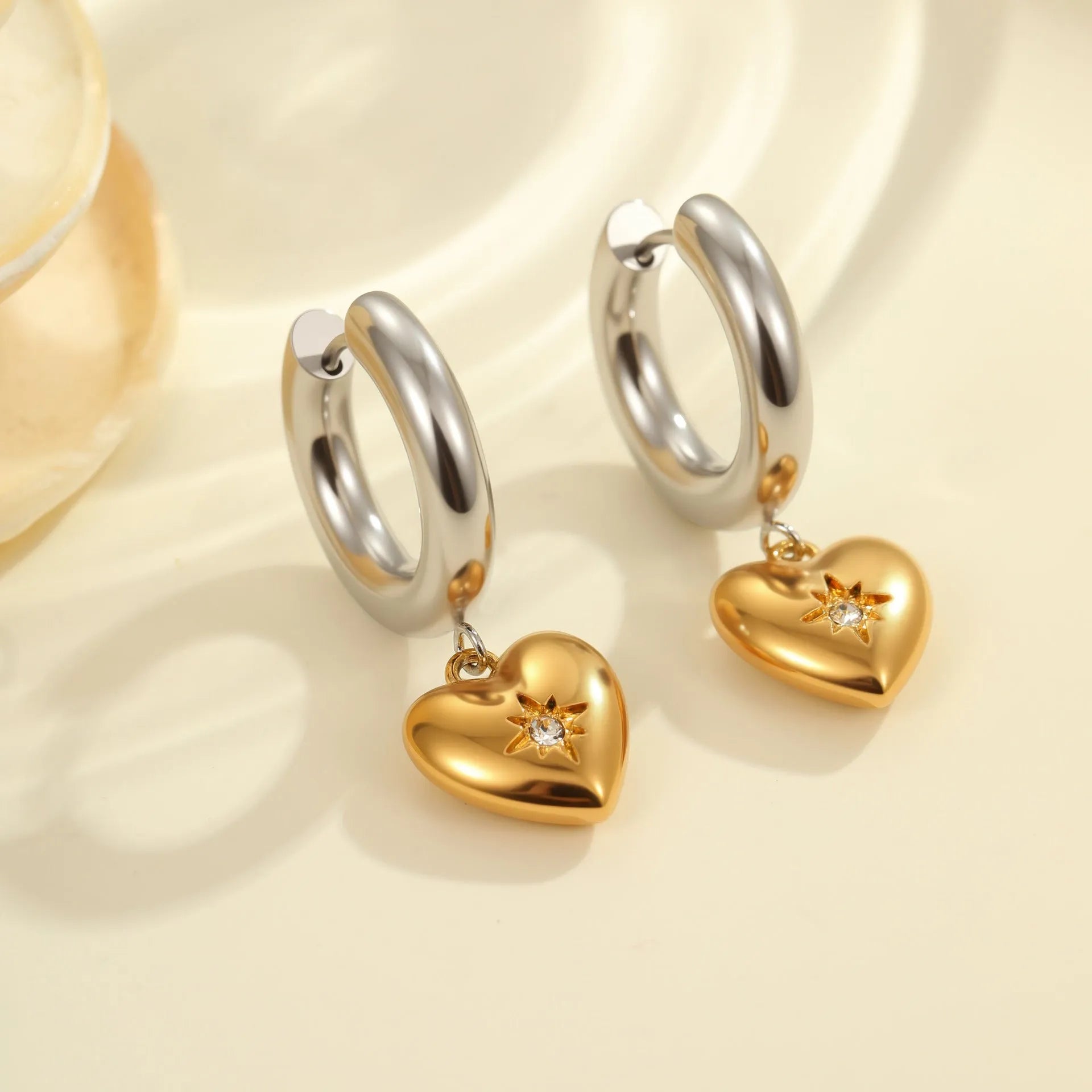 Women's stainless steel earrings with 18K gold plating in heart, star, and Christmas tree shapes.