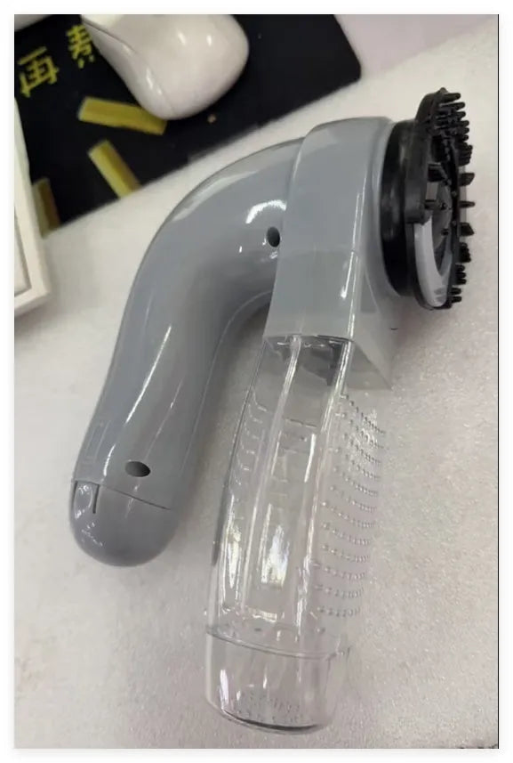Grey handheld pet hair vacuum cleaner with soft rubber grooming brush head