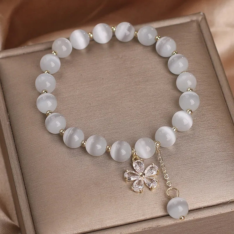 Women's white Cat's Eye crystal bracelet with flower tassel pendant and safety buckle closure