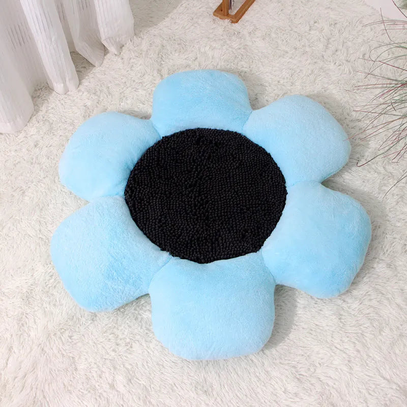 Round blue cat bed with high plush walls and soft filling, shown on a wooden floor.