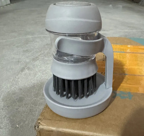 Automatic liquid adding cleaning brush in grey, with scraper edge and compact hand-held design