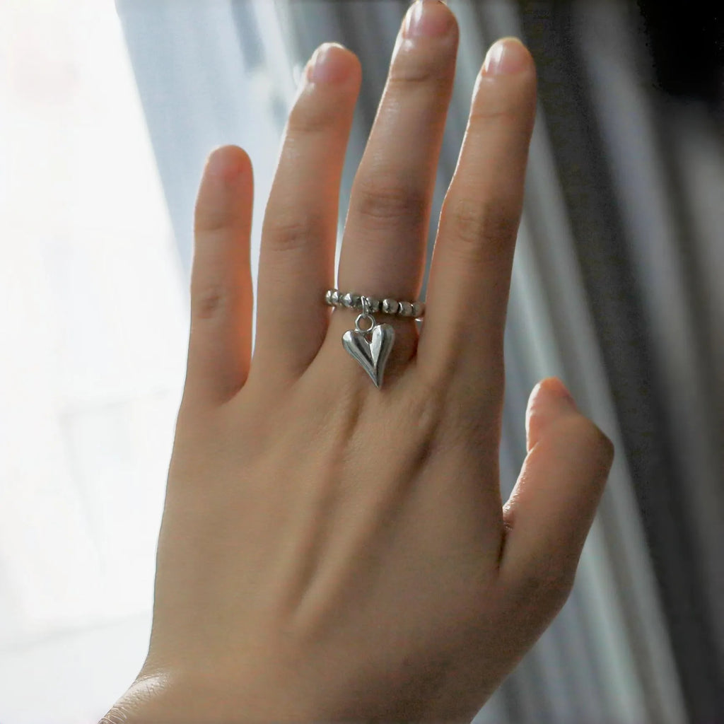 Handmade elastic beaded love ring with geometric heart design in gold and white electroplated finishes