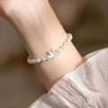 White shell bead bracelet with 925 silver rabbit charm on a black elastic string