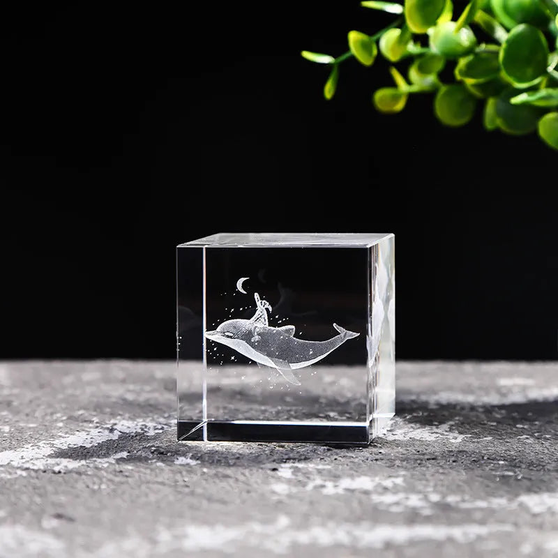 White crystal square ornament with engraved lotus design on a desk surface
