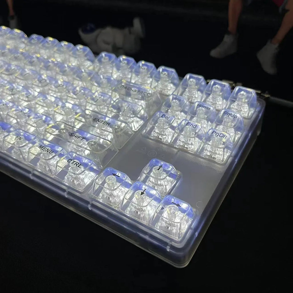 Transparent plastic 132-key mechanical keyboard key cap set displayed on white background