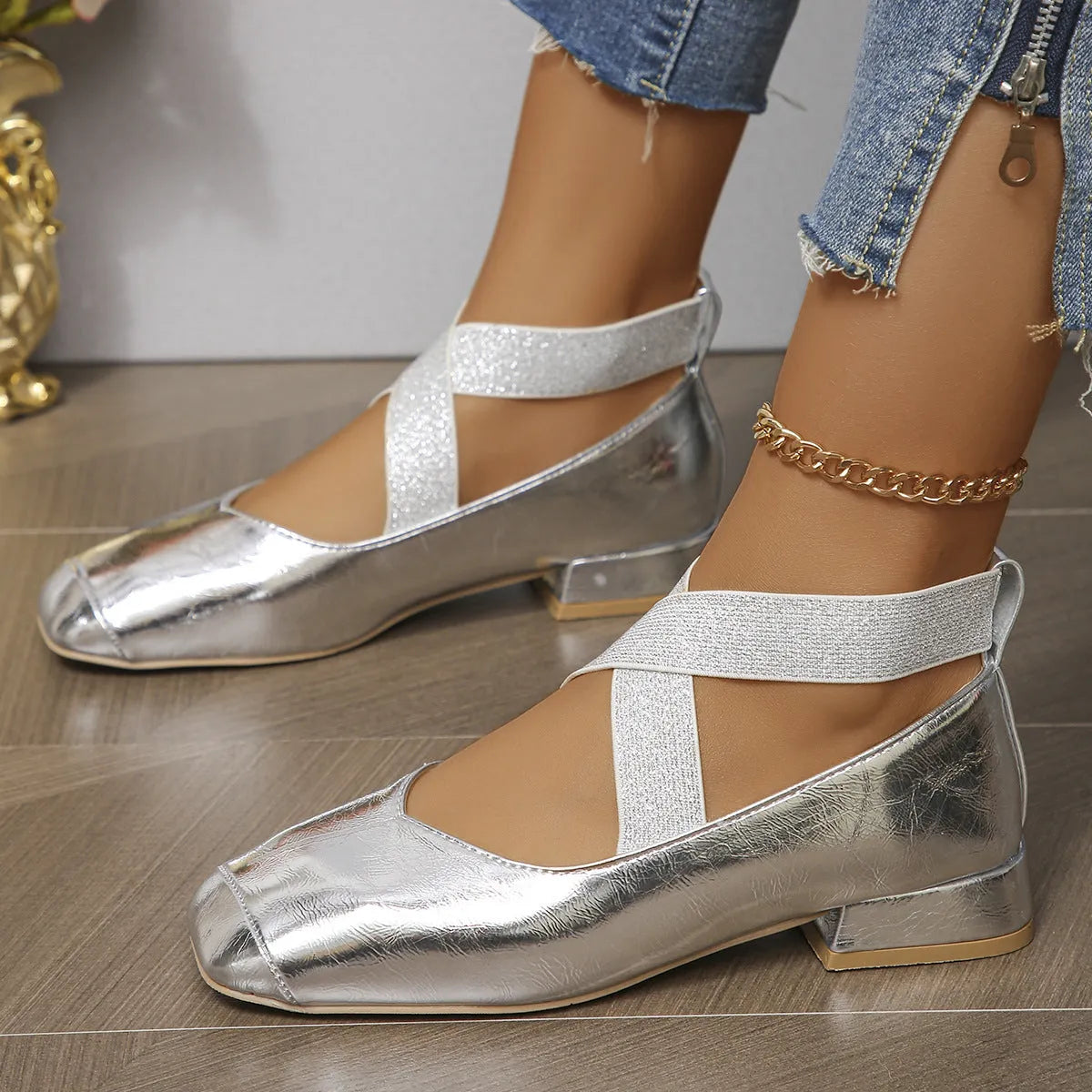 Gold slip-on evening pumps with a square toe and low heel on a plain background.