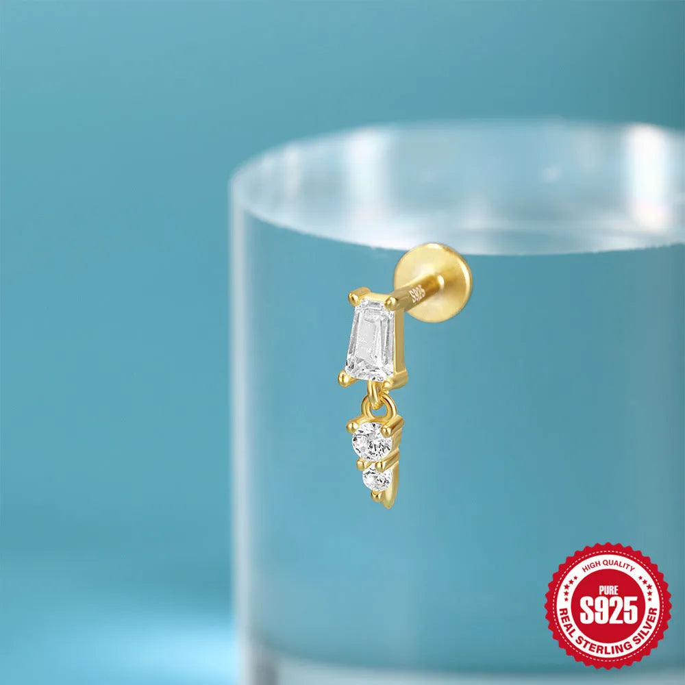 S925 sterling silver ear stud with XINGX inlaid tassel design in a gold colour.