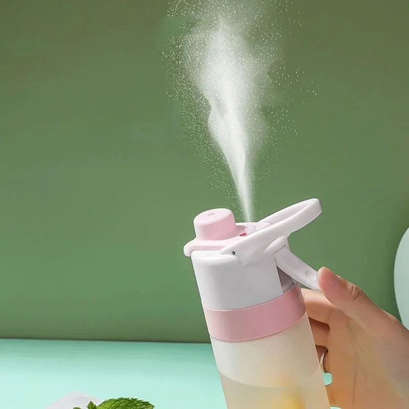White 700ml plastic spray water bottle with handle strap and leakproof lid.
