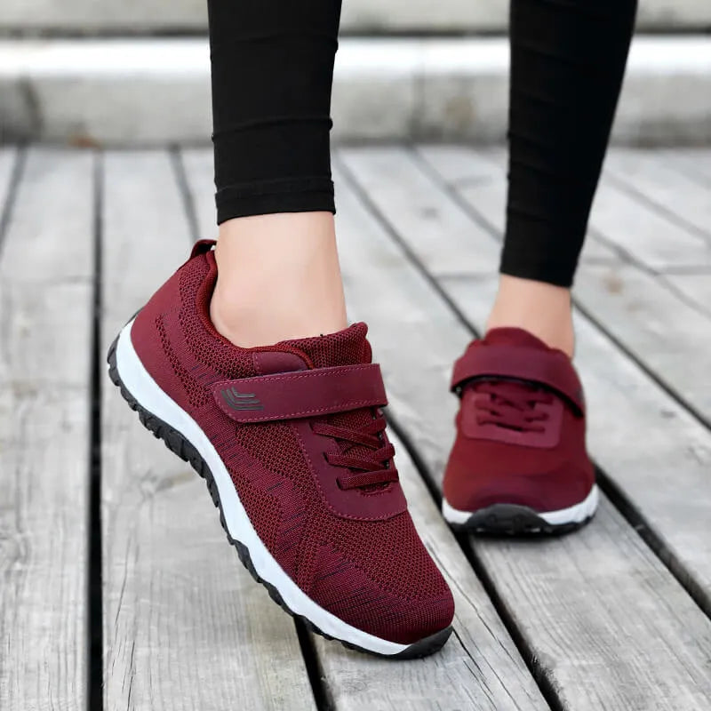Women's low-top casual shoes with Velcro strap, wedge heel, and breathable mesh upper in a grey purple colour.