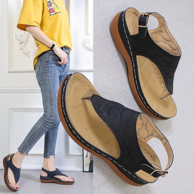 Women's black casual wedge heel sandals with an adjustable back strap buckle.