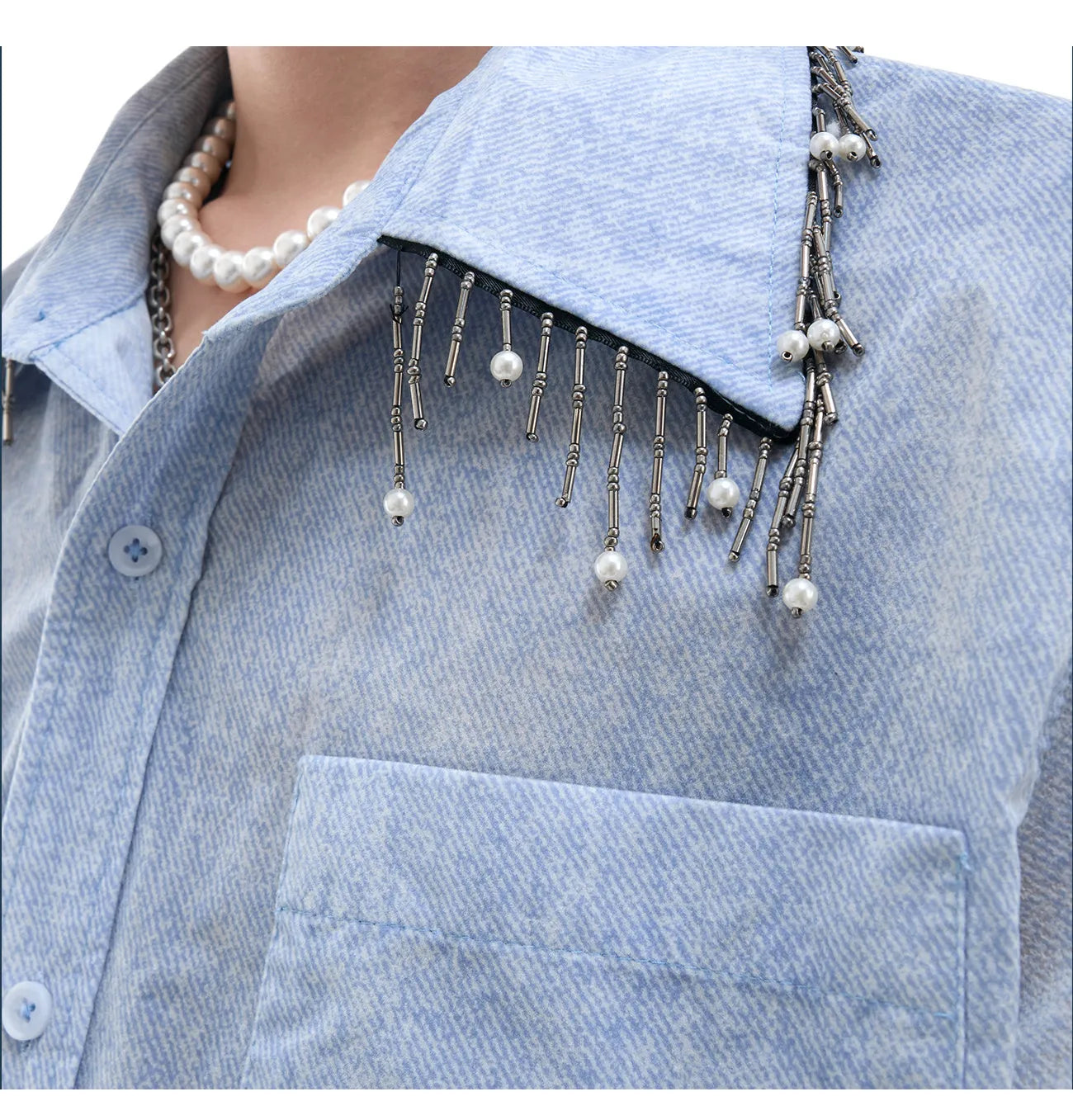 Man modelling a loose fit blue and white gradient shirt with quilted detailing and short sleeves.