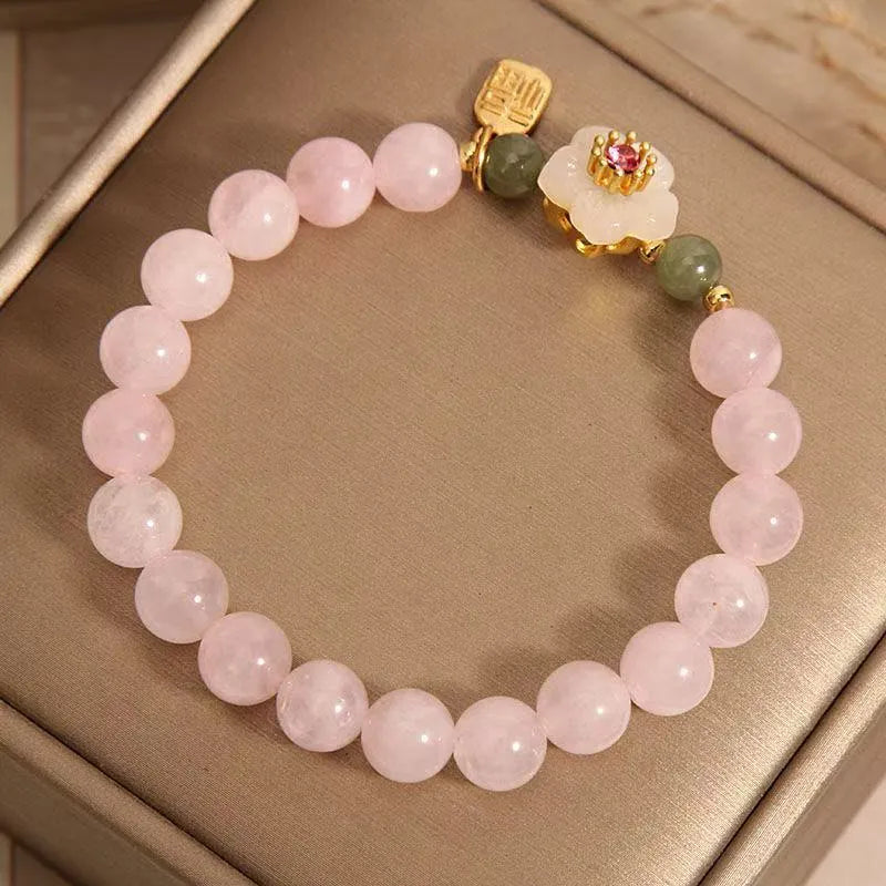 Crystal bracelet with Hetian jade beads showing peach blossom design, fruit charm, and camellia elements