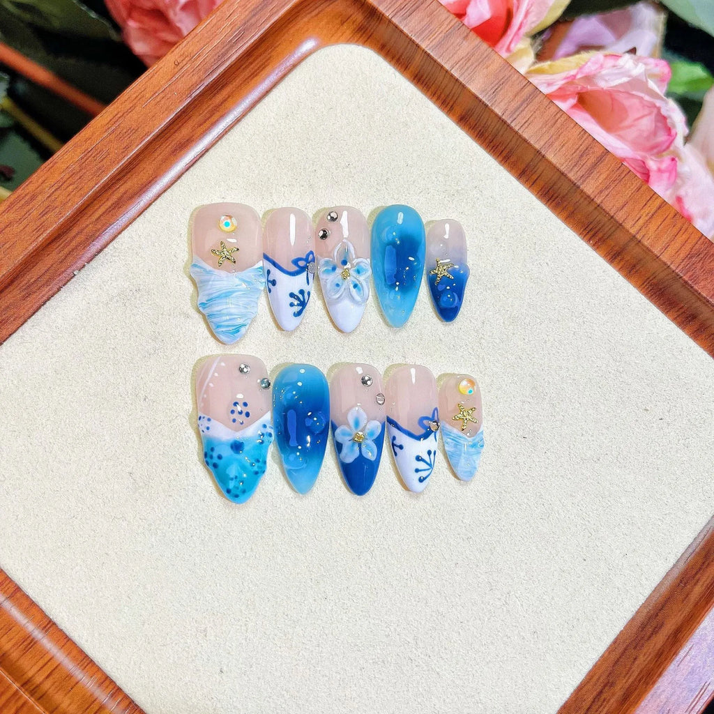 Blue hand-painted carved summer ice transparent plastic fake nails showing size range XS to L