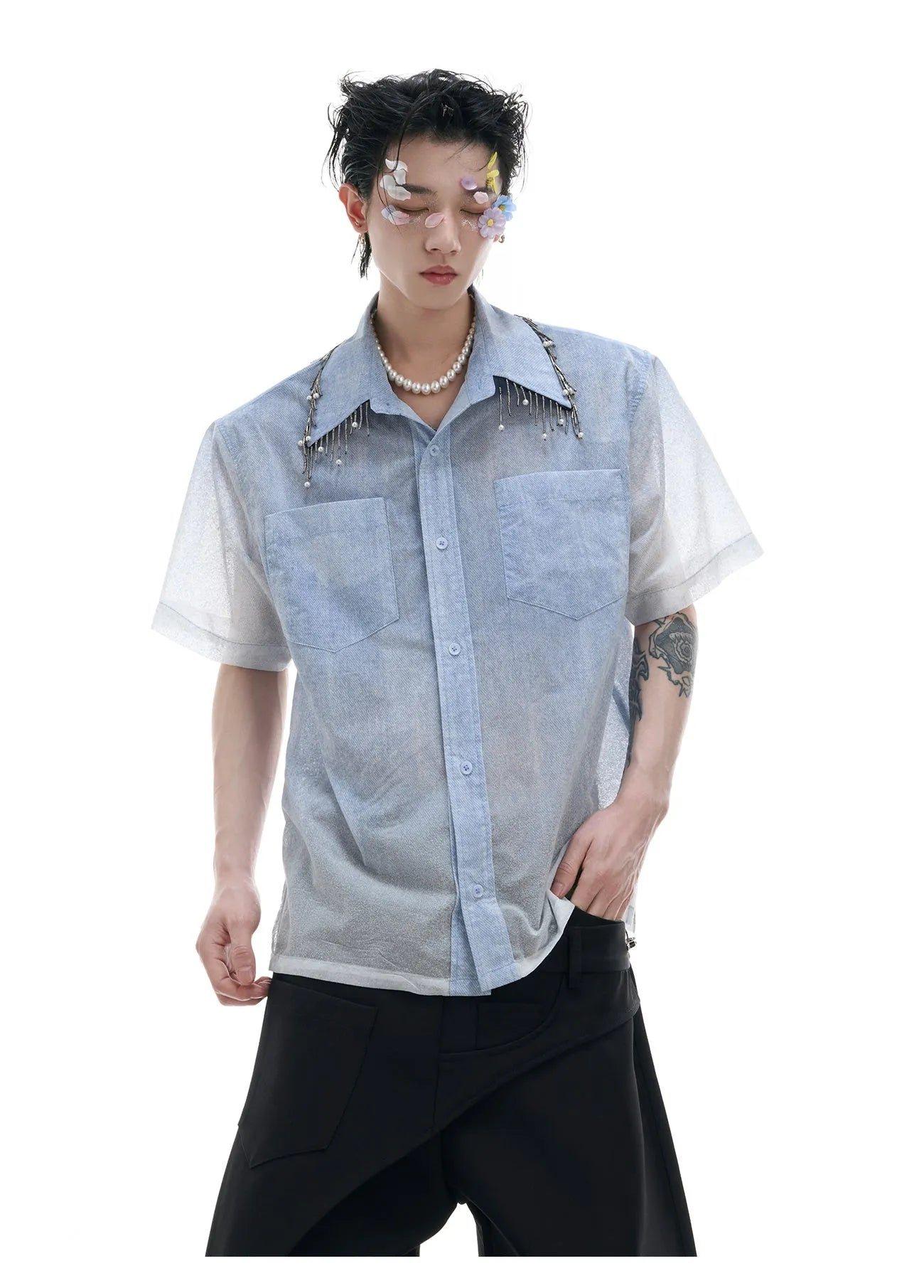 Man modelling a loose fit blue and white gradient shirt with quilted detailing and short sleeves.