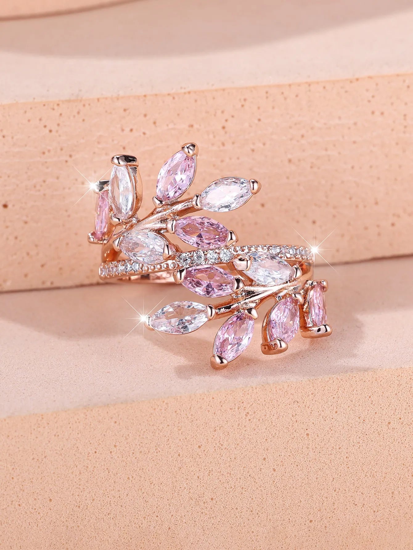 Adjustable copper leaf-shaped ring with a central horse eye zircon stone, shown in a rose gold finish.