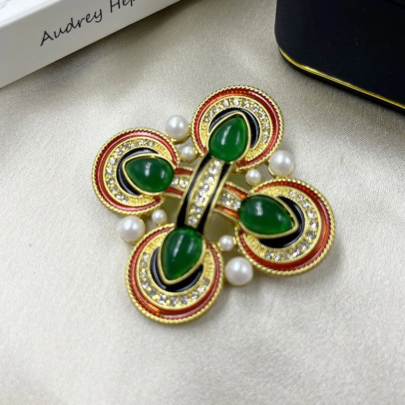 Close-up of vintage medieval baroque cross brooch with crystal accents on zinc alloy.