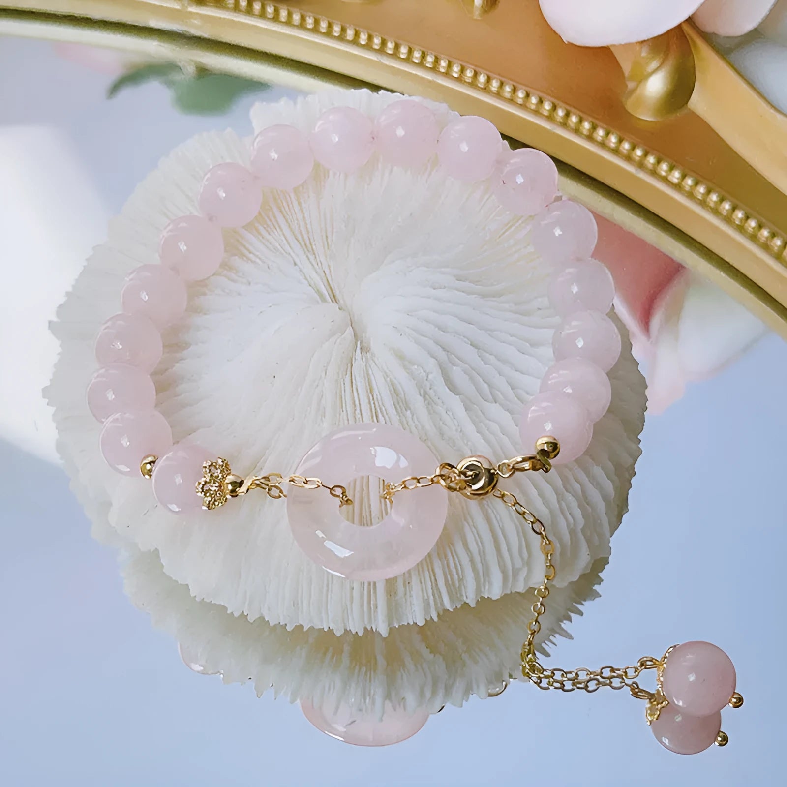 Pink crystal bracelet with peace buckle closure on woman's wrist