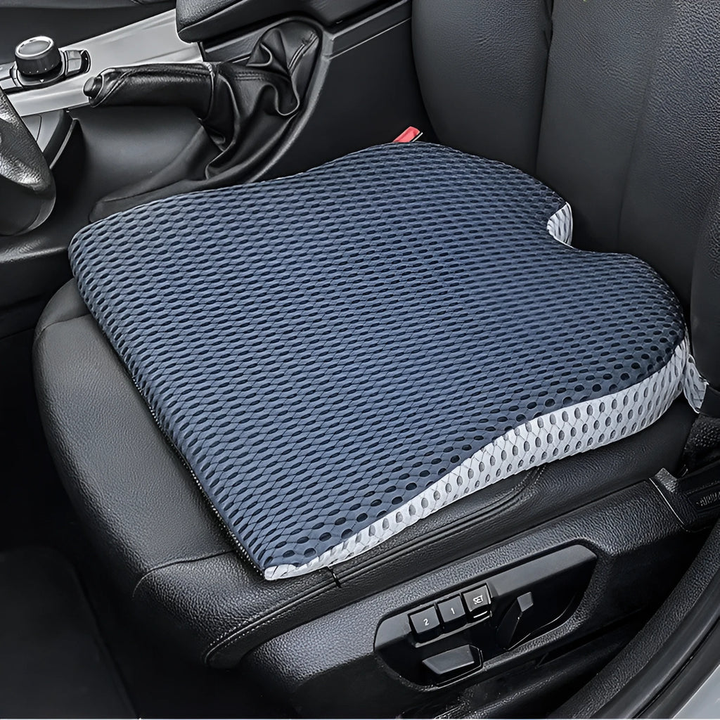 A solid-colour memory foam seat cushion with an adjustable strap, shown in creamy white.