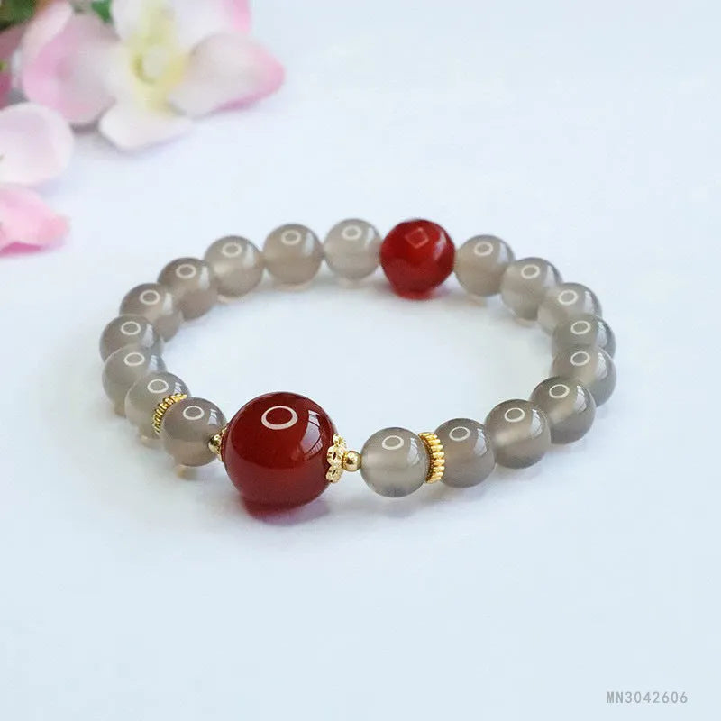 Women's smoky purple agate bracelet with 8mm geometric beads on a white background.