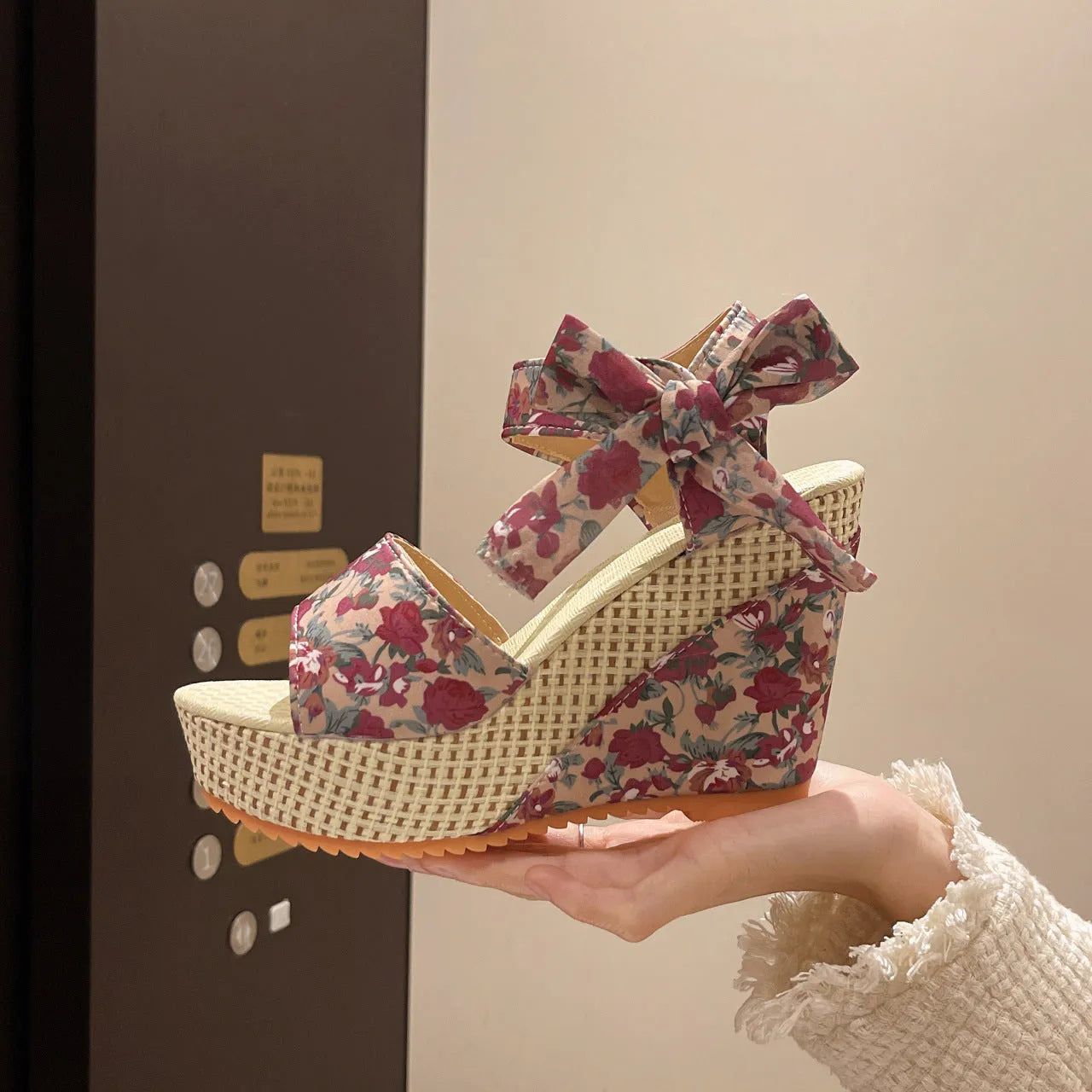 Women's floral wedge sandals with peep toe and ankle strap in pink, black, or blue.