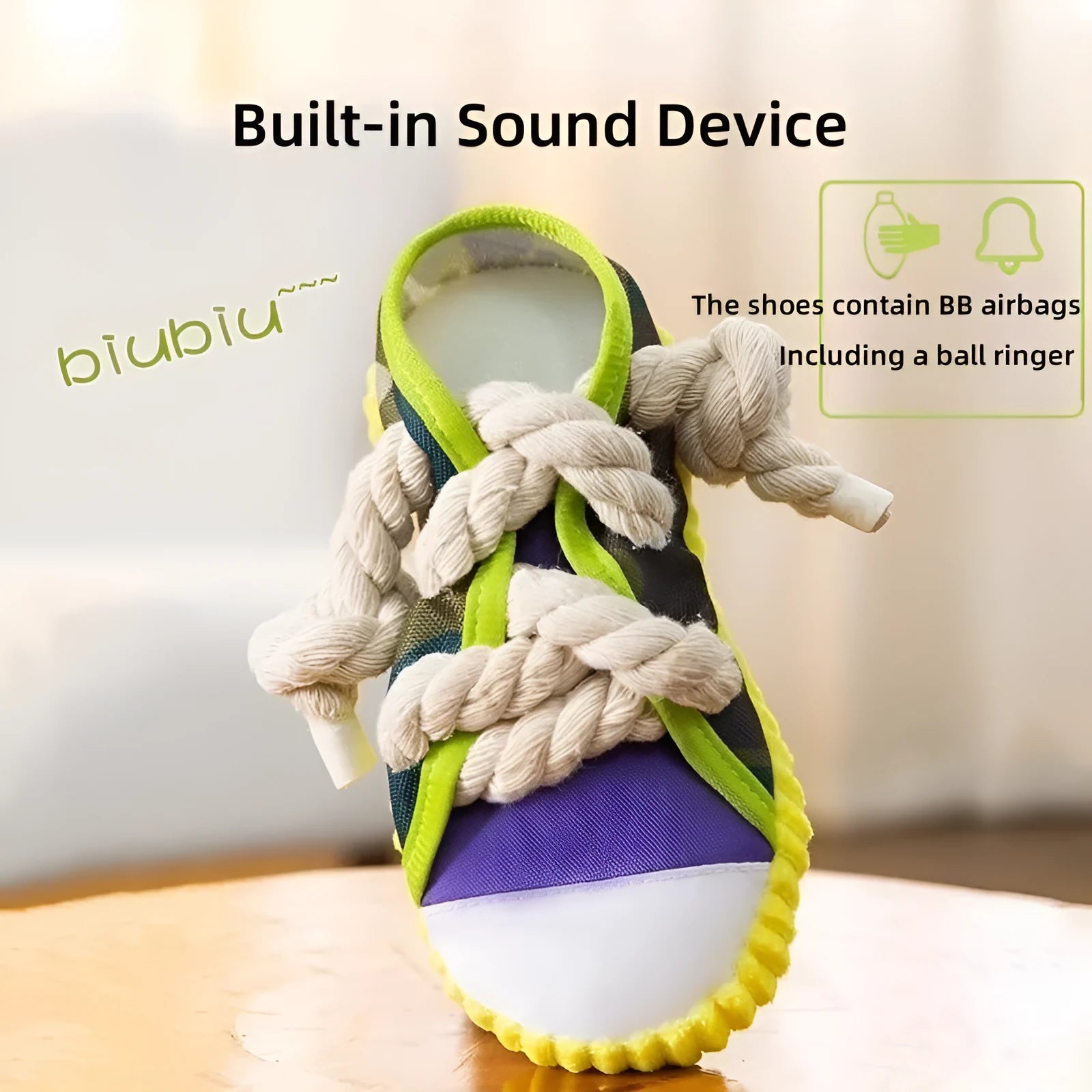 Grey and white dog toy slipper with black laces, blue sole, and a bell on the side