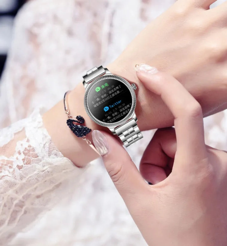 AK38 ladies smart watch with stainless steel Milanese mesh band and 1.09-inch colour screen displaying time.