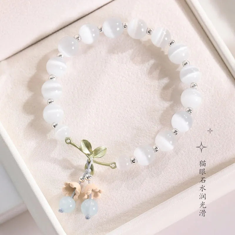 Close-up of electroplated opal cat's eye beaded bracelet for women with diamond-shaped charm