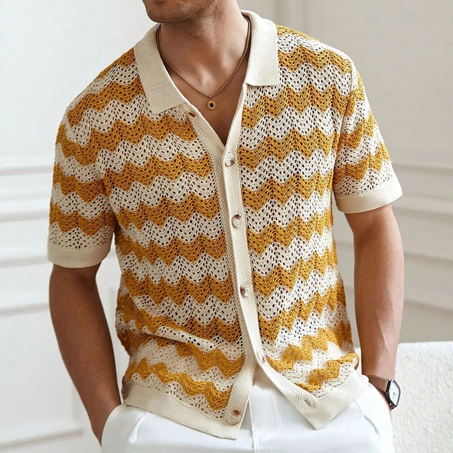 Man wearing a blue short-sleeve corrugated knit sweater with a hollow jacquard pattern, showcasing texture.