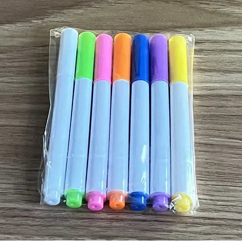 Acrylic DIY LED message board on a bracket, glowing softly with handwritten notes, alongside white and colourful pens.