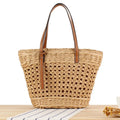 Beige horizontal square woven paper-string shoulder bag showing wide opening and adjustable strap