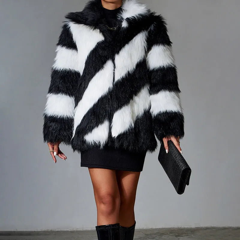 A picture colour faux fur coat with a contrast lapel and a textured fur collar, shown on a hanger.