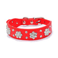 A black PU leather dog collar with glittering rhinestone flower studs and a metal D-ring.