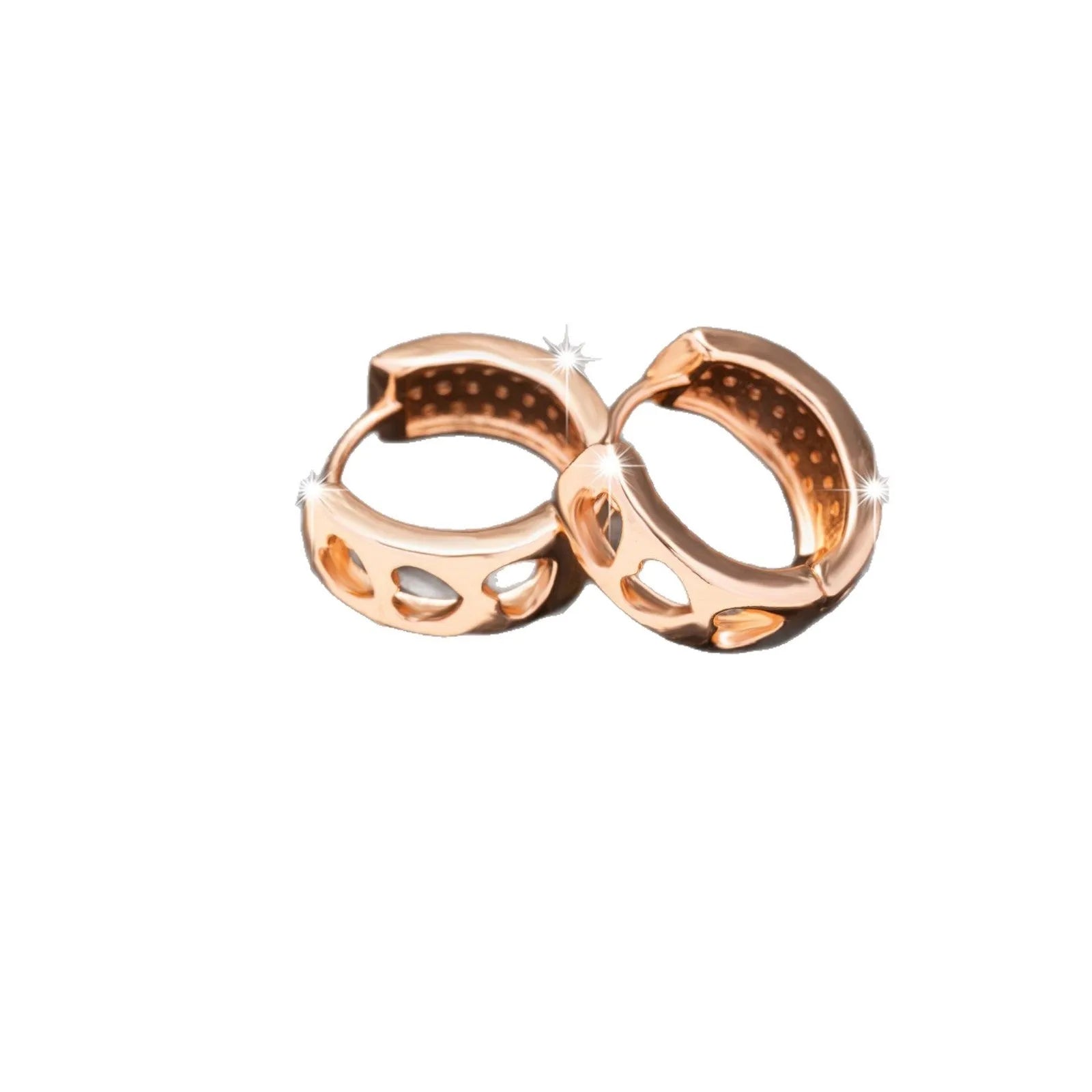 Close-up of a pair of rose gold circular hoop earrings with three small hollow heart shapes cut out of each band.