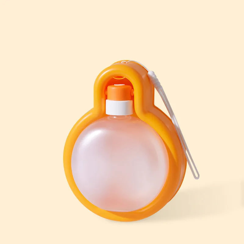 Green portable dog water bottle with pull-out drinking bowl, shown next to a dog.