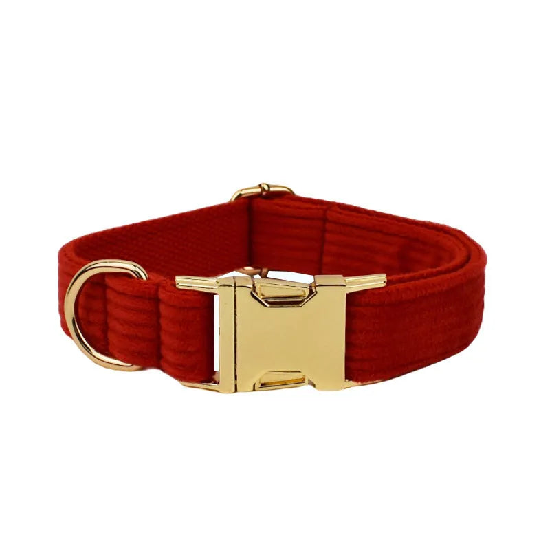 Red corduroy dog collar and leash set with matching vest, bow tie, and poo bag