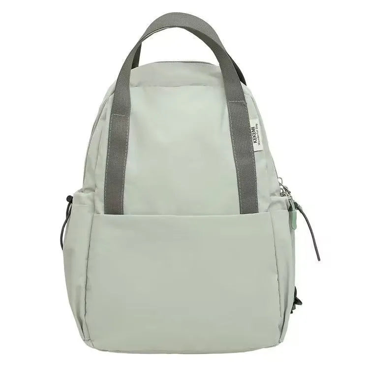 Solid colour nylon backpack with curved shoulder straps shown in five colour options