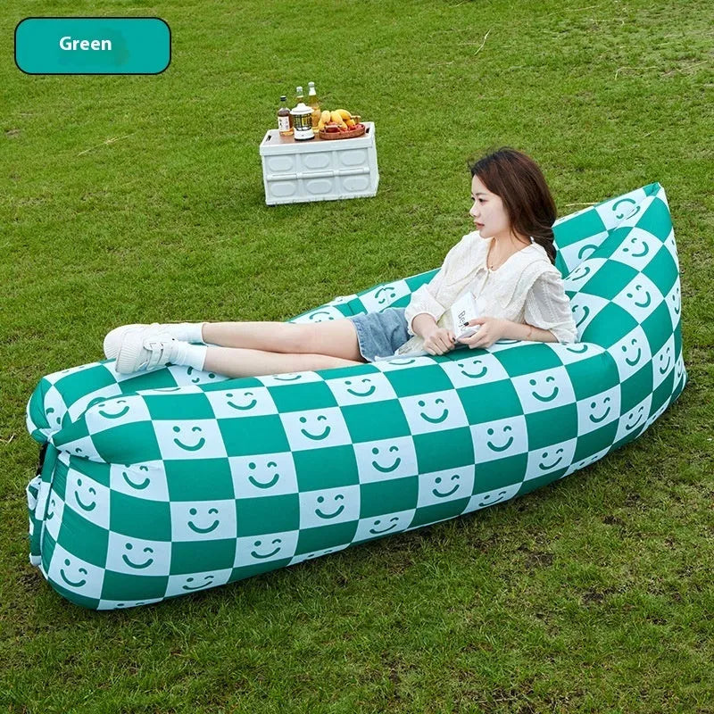 Inflatable lazy sofa in yellow smiling face tip colour, folded for transport with one-minute inflation valve visible