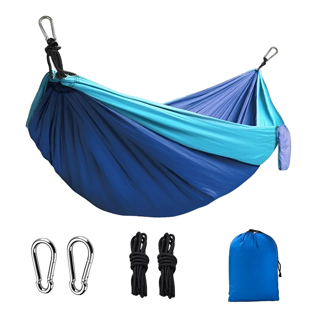 Sapphire blue parachute nylon hammock hung between trees, showing its full 270cm length and woven texture.
