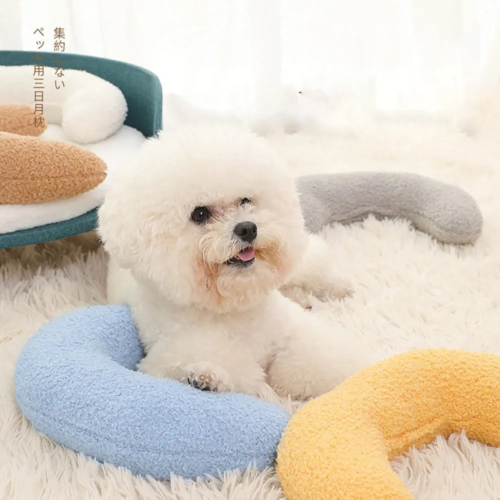 U-shaped blue cat pillow with adjustable collar placed on a sofa